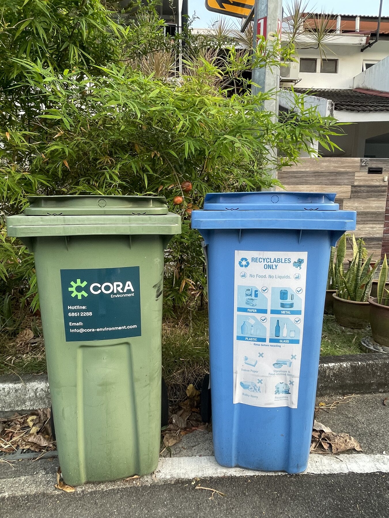 A general waste bin beside a blue recycling bin in Singapore